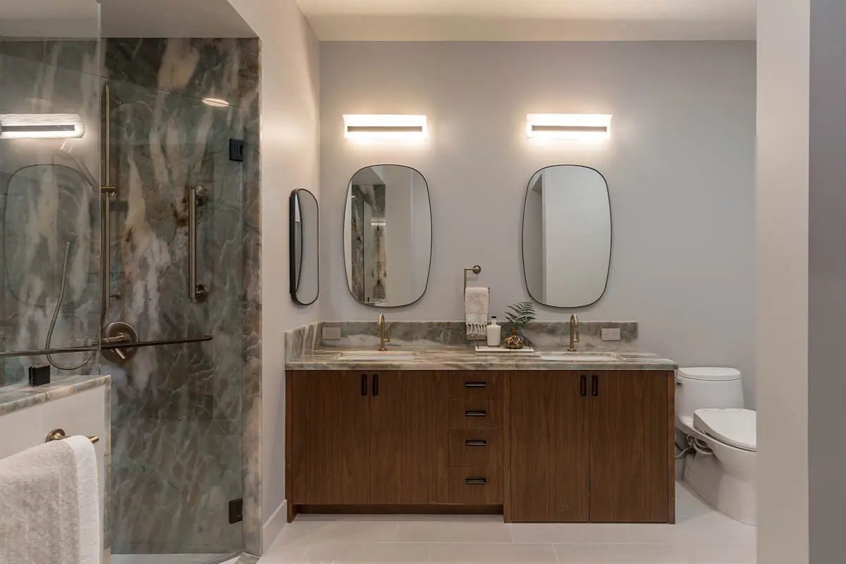 Accessible double vanity and roll-in marble shower from an accessible ensuite renovation in North York