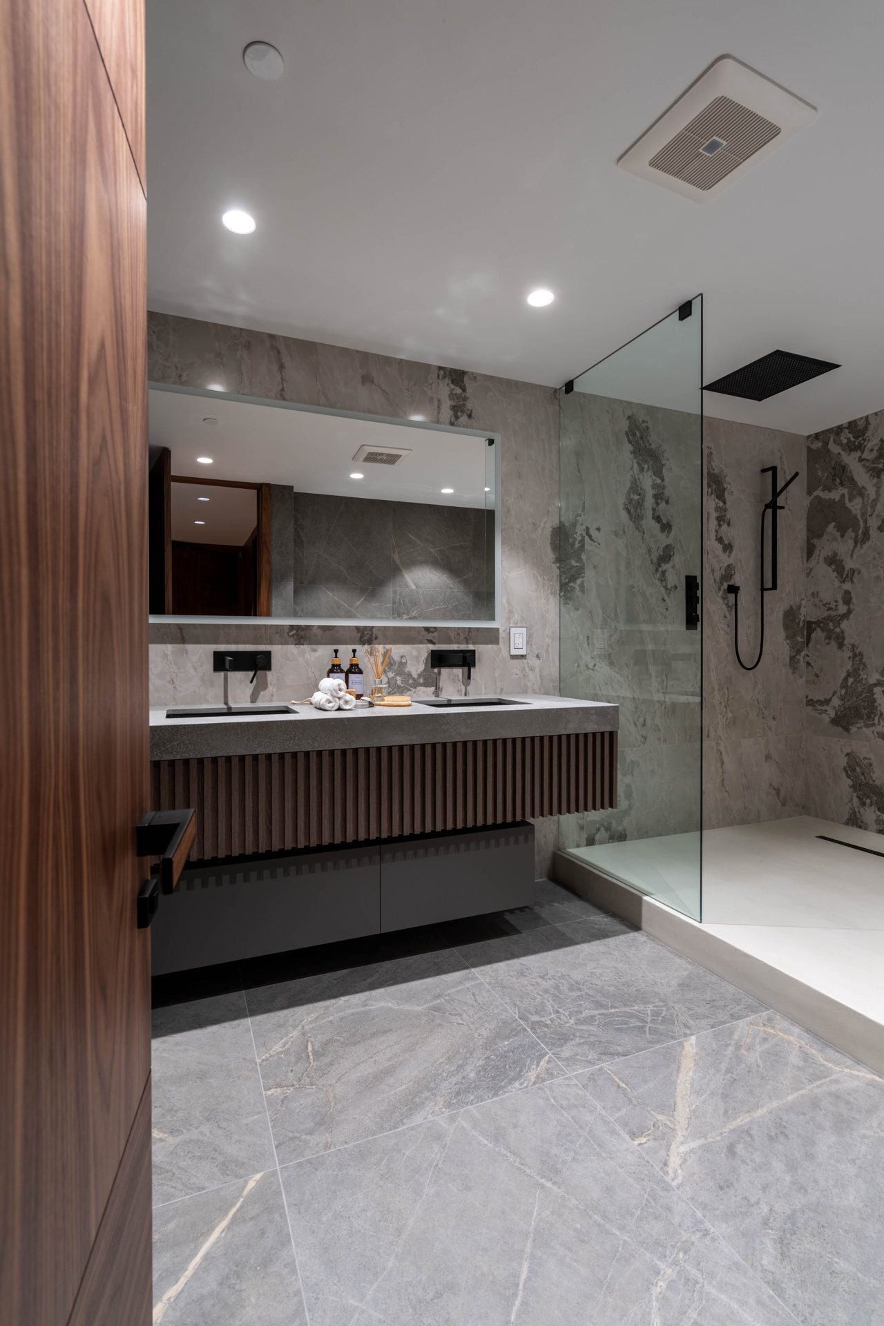 View through the ensuite door to the shower and walnut vanity, Toronto