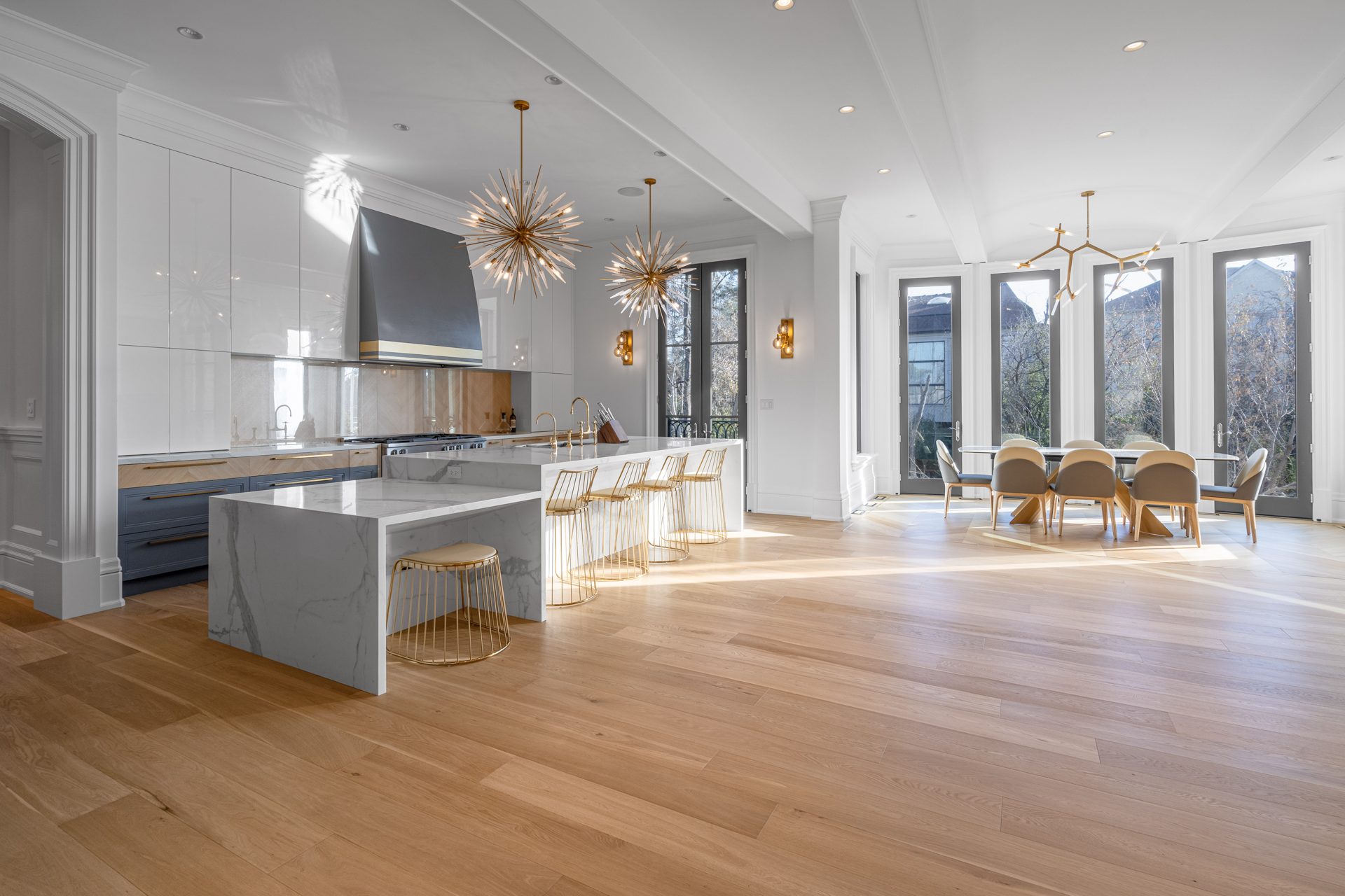 Open-concept custom kitchen with two-level marble island and dining area, Thornhill