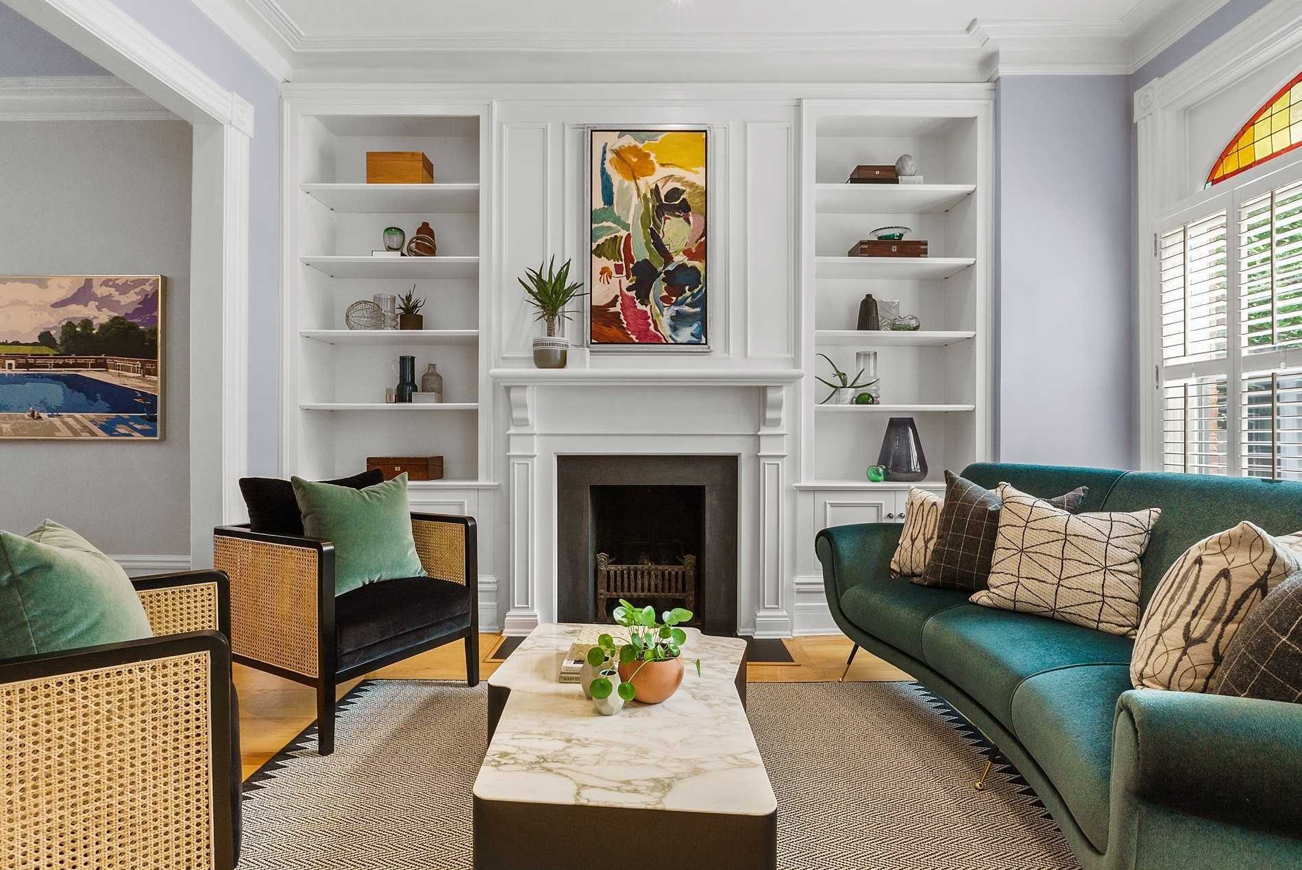 Living room with custom built-ins and restored stained glass from a full home renovation in The Annex, Toronto
