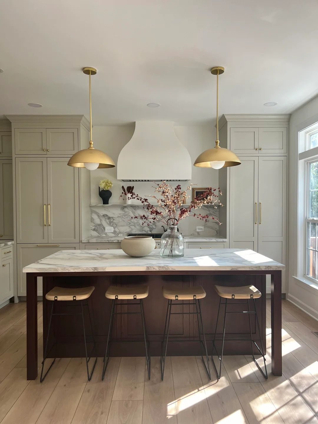 Cream custom cabinetry and marble backsplash from a kitchen renovation in The Annex, Toronto