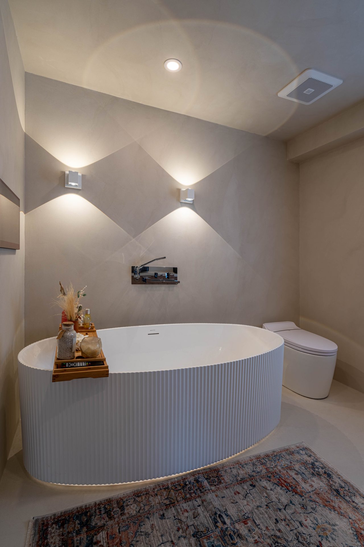 Freestanding tub under wall sconces with a heated towel rail, Richmond Hill